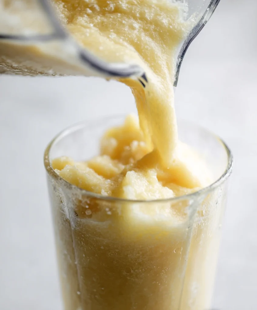 pouring pineapple frosty into glass